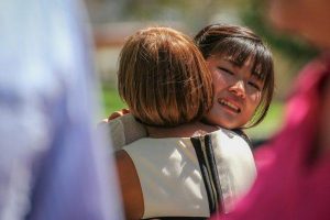 Palomar international student Ena Miyauchi, a friend of the victim, receives a hug from Palomar counselor Ismene Vassiliadis after speaking to the attendees of the Celebration of Life ceremony at Palomar, Sept.19, 2014. (Yoshikazu Yamashita/The Telescope)