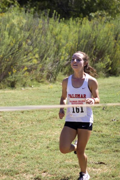 Palomar College Cross Country Invitational at Guajome Park. Steinhoff #161, is within feet of breaking through the finish line tape.