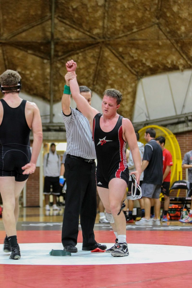 Oct. 15, 2014 | Palomar College wrestler Erik Collins (r) raises his hand in victory over Mt. San Antonio College Zachary Mitchell (l). Collins won the match 4-3. The Mounties won the overall match 26-14, which took place at The Dome at Palomar College. (Philip Farry/The Telescope)