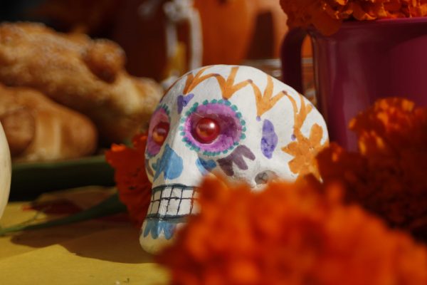 PUENTES decorated their club booth in a Dias de las Muertos theme with sugar skulls, ofertas, and marigolds at the Halloween Escape event Oct. 30, 2014. (Angela Marie Samora/The Telescope)