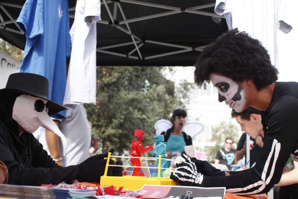 The Active Minds booth had literature about the club, candy, and rock 'em sock 'em robots at the Halloween Escape event at Palomar College, Oct. 30, 2014. (Angela Marie Samora/The Telescope)