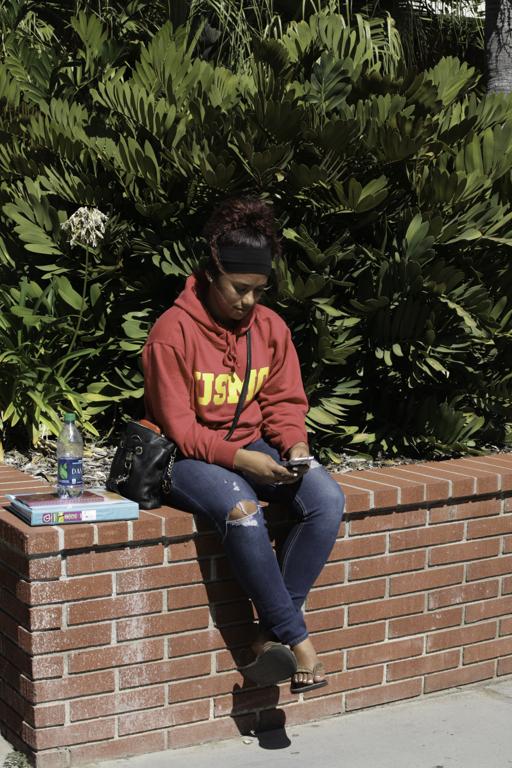 Dayja Aguilar texts between classes on her Galaxy S3 at Palomar College on Oct. 8 2014. (Erika Shasky/The Telescope)