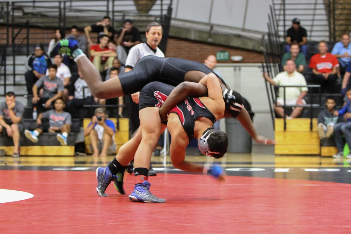 Oct. 15, 2014 | Palomar College wrestler Alex Graves throws Mt. San Antonio College wrestler KeAndre Johnson to the mat during the first period. Graves ranked #1 defeated Johnson ranked #2 by a score of 9-4. The Mounties won the overall match 26-14, which took place at The Dome at Palomar College. (Philip Farry/The Telescope)