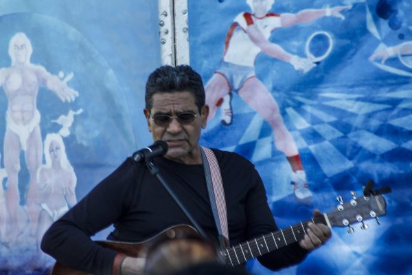 Edgar Oliveras performs during the Day of the Dead celebration at Palomar College, November 5, 2014. In the background is a replica of his mural "Espirical Transformacion." (Angela Marie Samora/The Telescope)