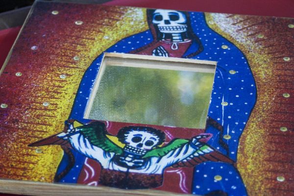 Day of the Dead altars are often decorated with sugar skulls and small mementos of the deceased. (Angela Marie Samora/The Telescope)