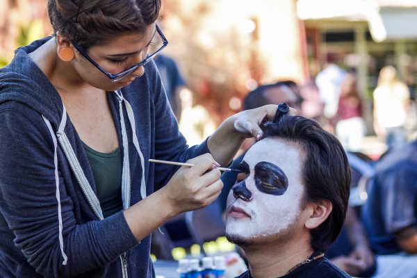 Edgar Godoy gets his face painted during the Day of the Dead festivities at Palomar College, Nov. 5, 2014. (Angela Marie Samora/The Telescope)