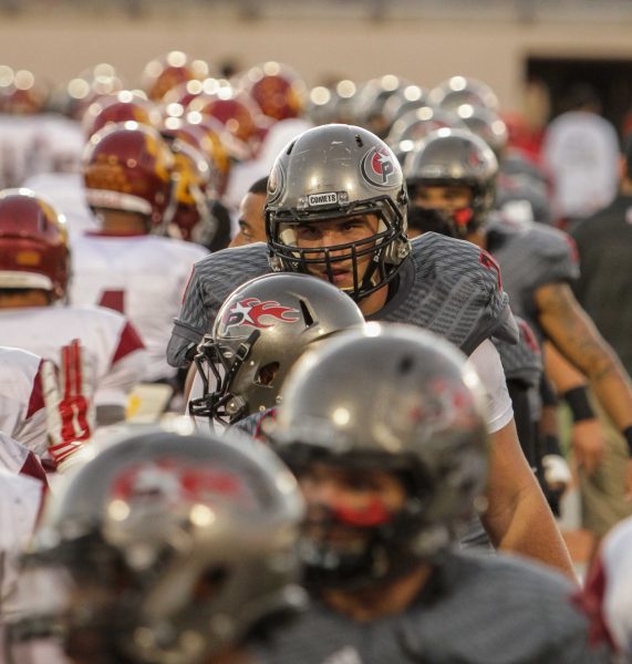 A line of Palomar football players walk and congratulates the opposing team players (Glendale).