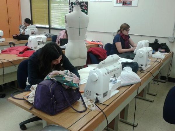 Students work on their designs at sewing machines during class on Nov. 14, 2014. (Hayley Ulle/The Telescope)