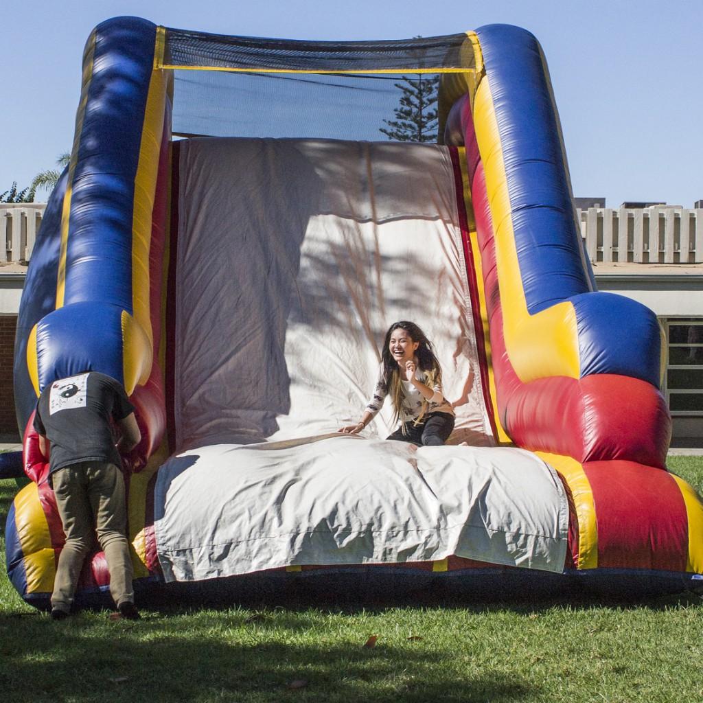 Marshal Fischer waits for Song Nguyen at the end of the bouncy obstacle course during the ASG hosted Comet Celebration, Oct. 22, 2014. (Angela Marie Samora/The Telescope)