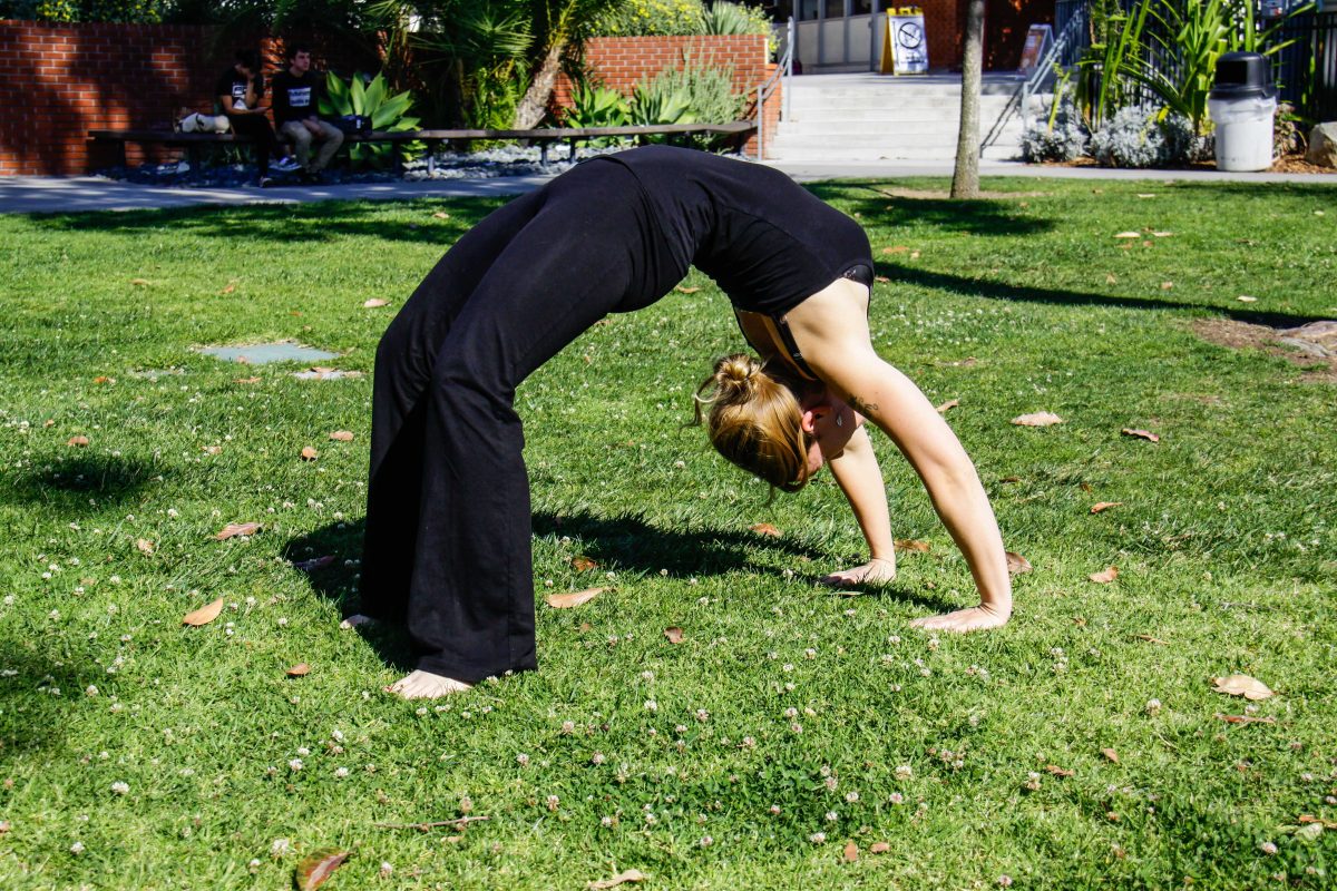 Susan Whaley demonstrates the Wheel Pose, otherwise known as the Upward Bow, a technique used to increase energy. (Daniel Kresge/The Telescope)