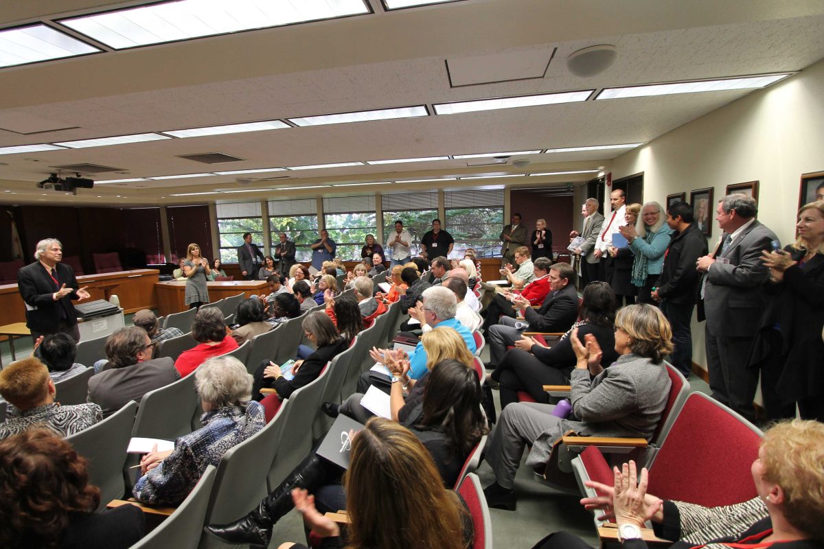 Dr. Richard Mahon (standing front) of the Accreditation Evaluation team speaks with Palomar College faculty during the College Forum in the governing board room on March 3, 2015. (Justin Sumstine/The Telescope)