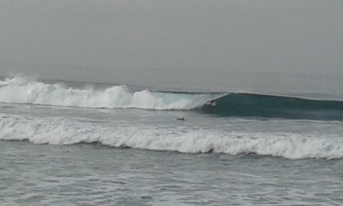 A photo I caught with my phone before heading out; a surfer in the barrel in South Oceanside. (Peter Bright/The Telescope)