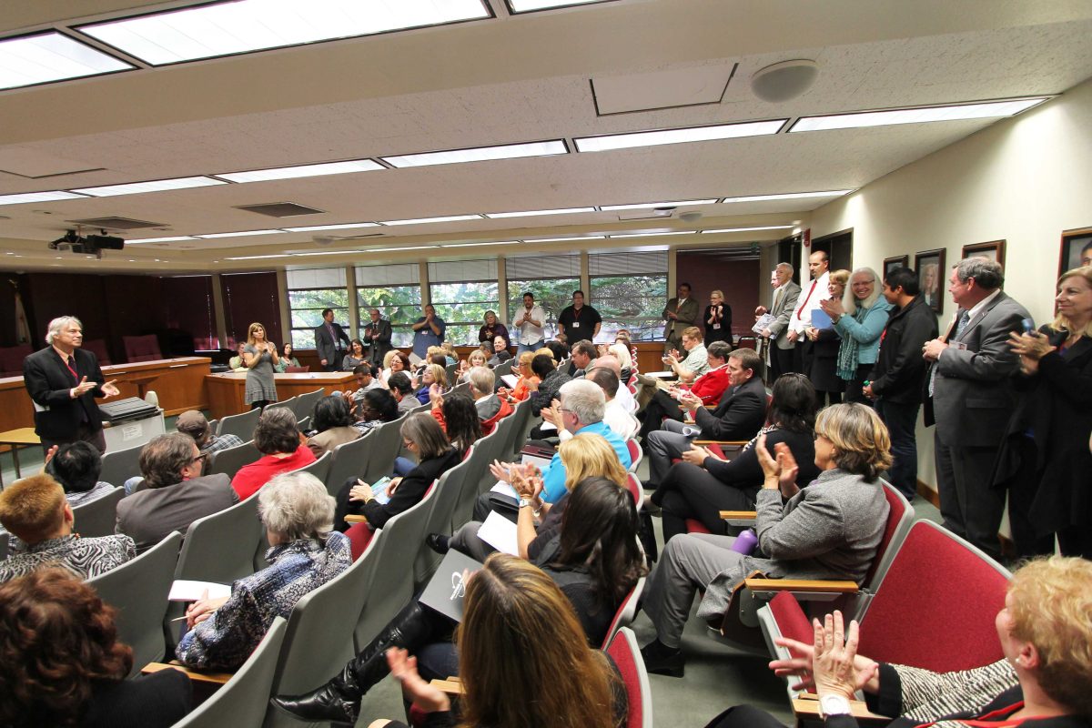 Dr. Richard Mahon (standing front) of the Accreditation Evaluation team speaks with Palomar College faculty during the College Forum in the governing board room on March 3, 2015. (Justin Sumstine/The Telescope)