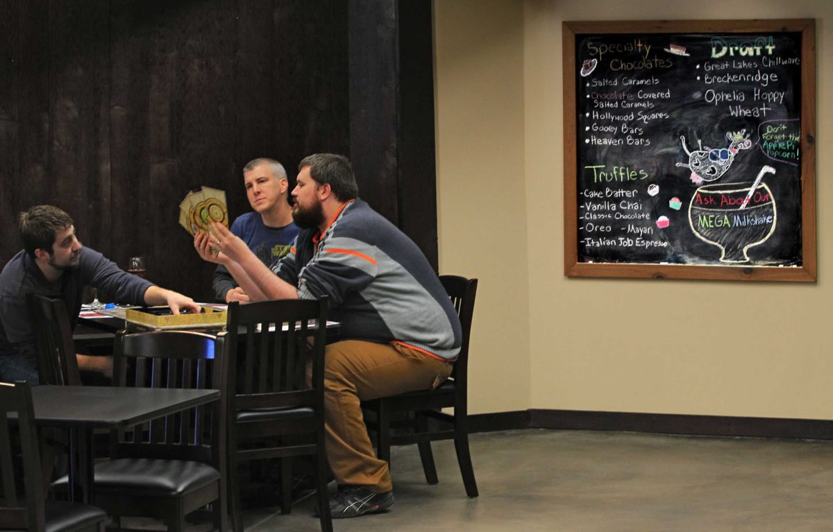 Nick Oostdyk, from left, Dave Brittingham and Brian Collins enjoy a beverage while getting ready to play the Lords of Waterdeep board game during a visit to the newly opened Malted Meeple on Saturday, April 4, 2015, in Hudson, Ohio. The business is a combination malt shop, craft beer bar and place where patrons can play board games like Dungeon & Dragons. (Ed Suba Jr./Akron Beacon Journal/TNS)