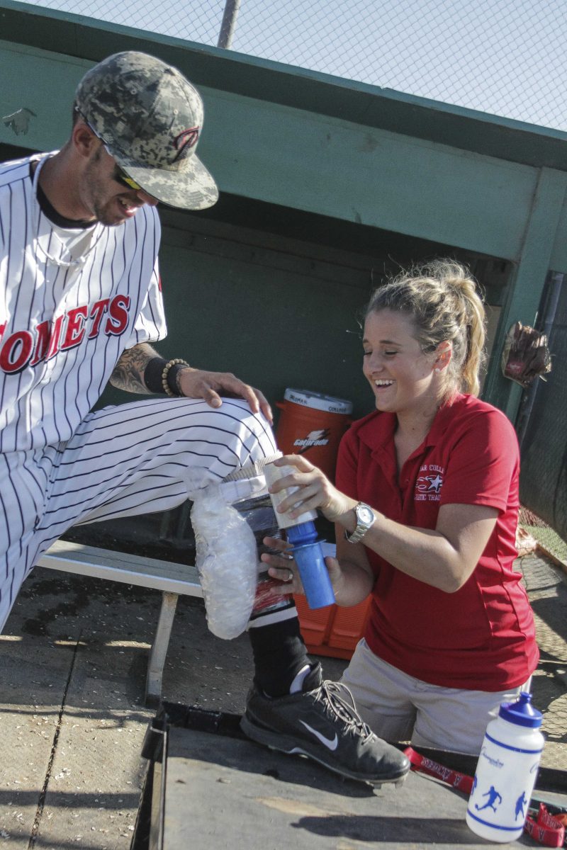 Palomar trainer Amber Gates works on the calf of shortstop Dylan Breault. (Philip Farry/The Telescope)