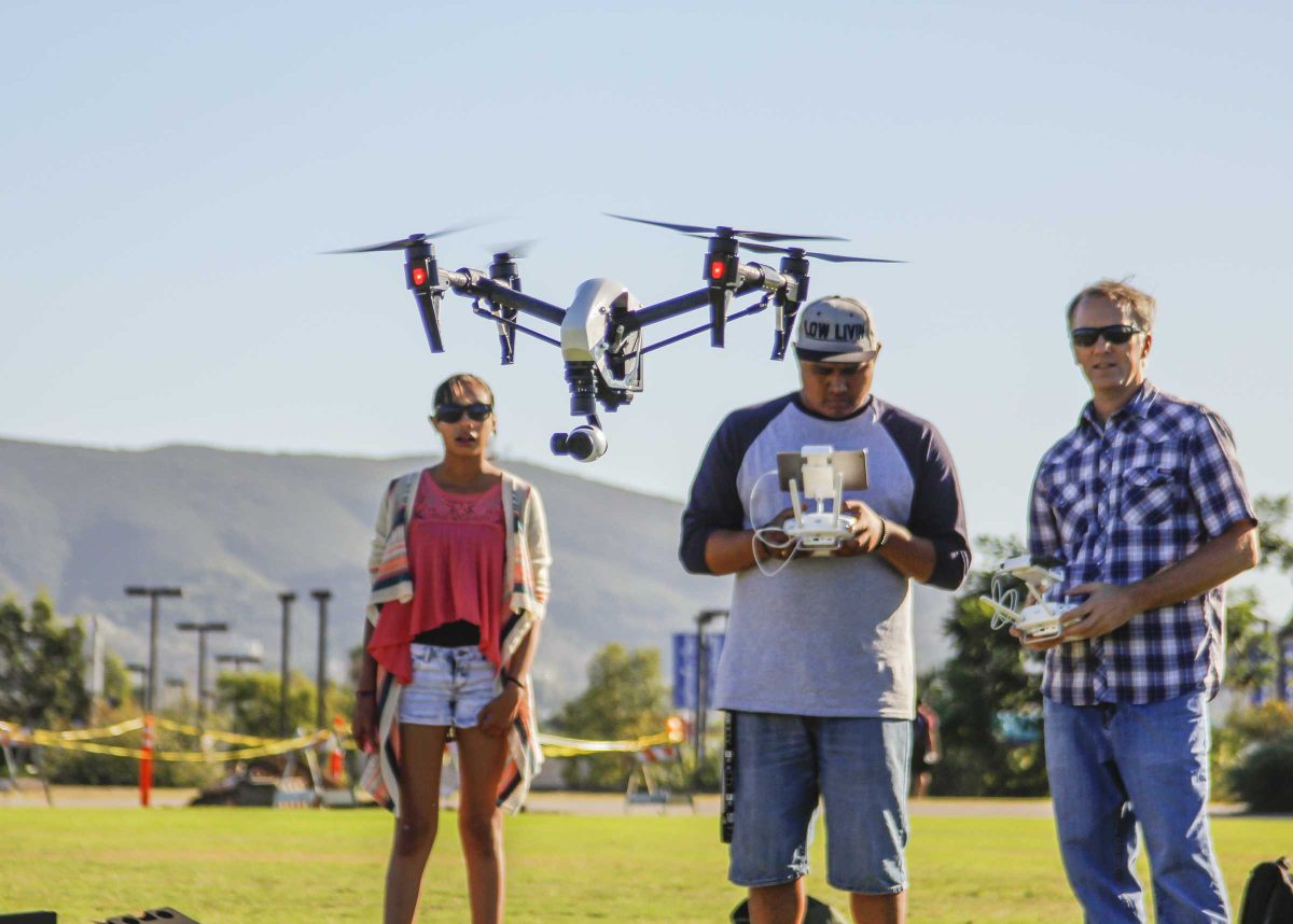 Victor Ramirez (c) is flying his U.A.V DJI-S900 along side of Professor Mark Bealo (r) and student Michelle Ramierz ( l). Victor Ramirez is one of 22 students in the Digital Imaging with Drones course at the San Marcos campus. Sept. 2015. (Hanadi Cackler/The Telescope)