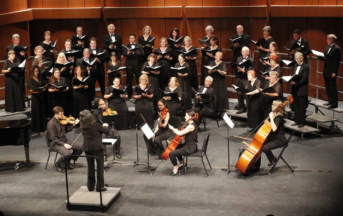 Sally Husch Dean (front) directs the Palomar College Chorale and Violin Quartet on Nov. 12, 2015 at the Howard Brubeck Theatre. The Palomar College Chorale and Chamber Singers performed with the Mesa College Vocal Ensemble. The concert was dedicated to Alice Parker who is an inspiration in the Chorale community. (Coleen Burnham/The Telescope)