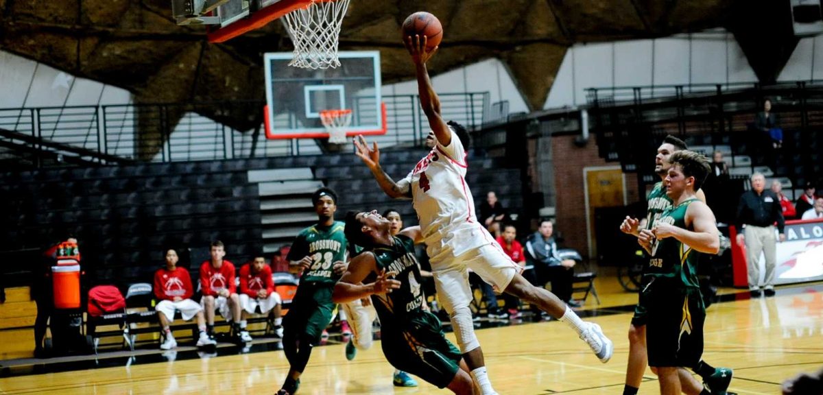 Kevin Hardyway (4) drives in the lane for a layup over Grossmont players. The Comets went on to defeat Grossmont 69-66. (Johnny Jones/The Telescope)