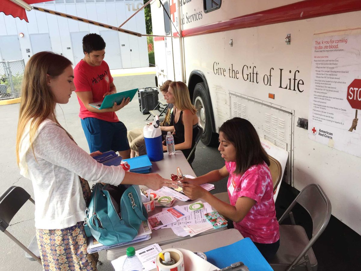 Red Cross volunteer Denisse Sanchez prepares Mason Smith for donating blood during the Palomar College Blood Drive on Tuesday Sept. 22, 2015 in Parking Lot 6. (Yvette Monteleone/The Telescope)