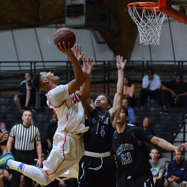 Palomar College guard Deven Riley (20) shoots over Citrus College guard Donn-Christian Corbin (14) during the First Round Southern Regional Playoff game on Feb. 24, 2016 at the Dome. Citrus College won 77-63. (Tracy Grassel/The Telescope)