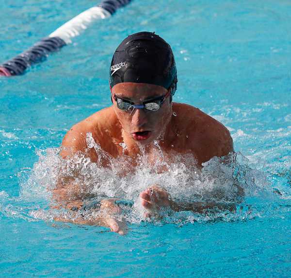 A male Palomar swimmer does the butterfly stroke in a pool.