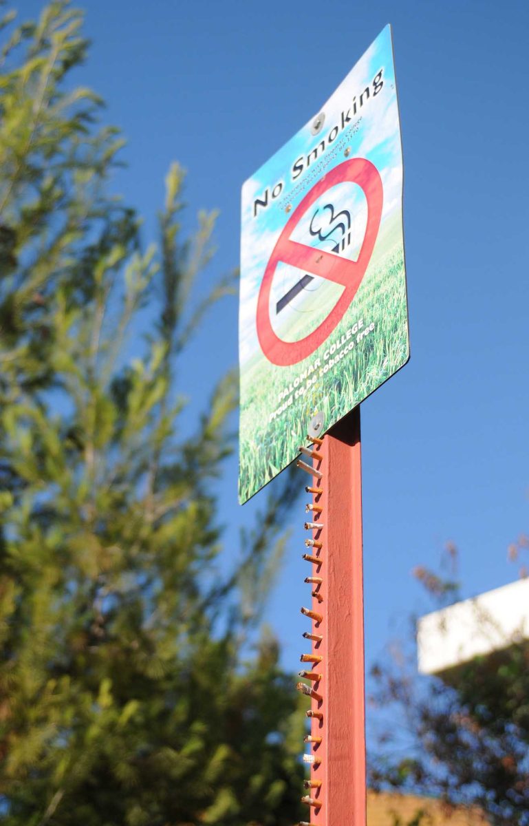 A Palomar College No Smoking sign near the library is decorated with cigarrette butts. (Yvette Monteleone/The Telescope)