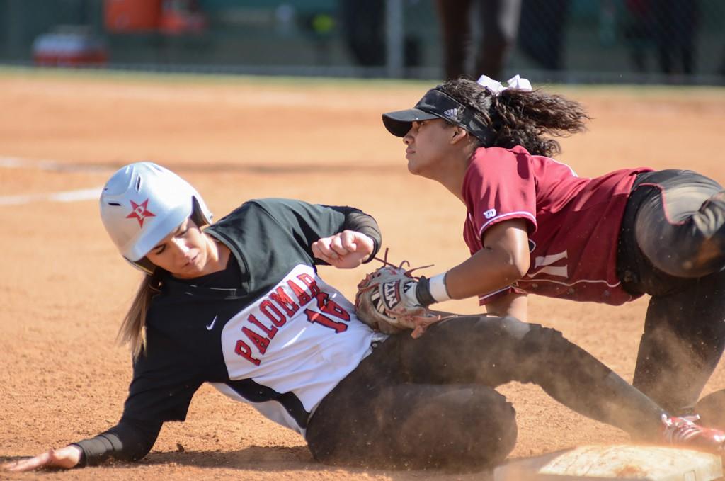 Palomar's Kealani (Nani) Leonui (#16) slides safely into third base colliding with San Diego City College Knights infielder Alyssa Garrette (#11) during the March 30, 2016 game. Palomar won at home 9-0. (Tracy Grassel/The Telescope)