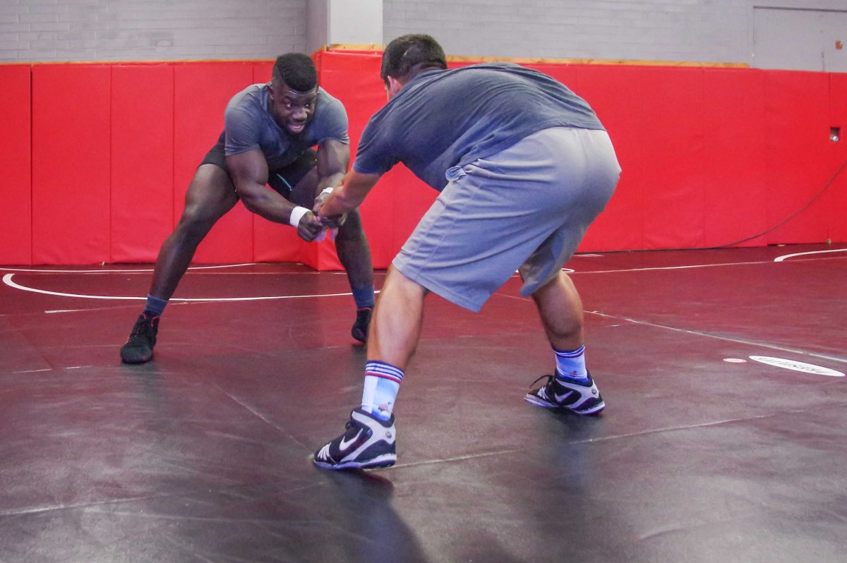 Two male Palomar wrestlers circle each other during a match.