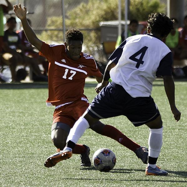 Palomar defender Ty Sample (#17) dives in to win the ball back from Cypress College defender Peter Carranza (#4) in a 2-1 loss at Minkoff Field on Sept. 6, 2016. (Eric Szaras/The Telescope)