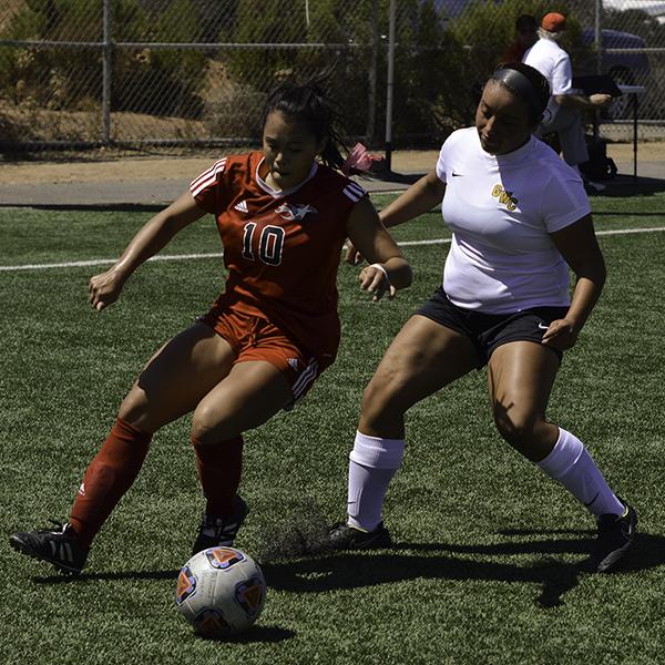 Palomar midfielder Adriana Gutierrez (#10) tries to keep the ball in bounds on Minkoff Field. Despite her goal in the 63rd minute and 2 others by Palomar forward Grace Busby, Palomar was defeated 4-3 by Golden West College on Sept. 9, 2016. (Eric Szaras/The Telescope)