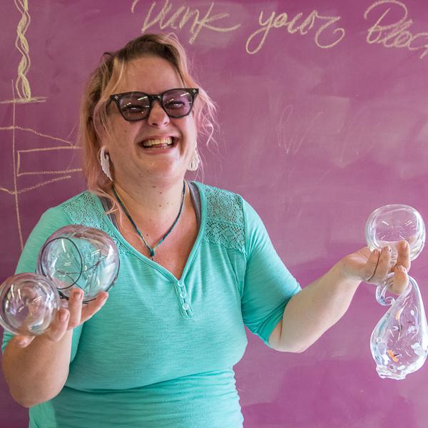 Palomar Student Artist Kris Bandanas proudly poses with some of the blown glass artwork that she has created in her glass blowing class on October 24, 2016. (Joe Dusel/The Telescope)