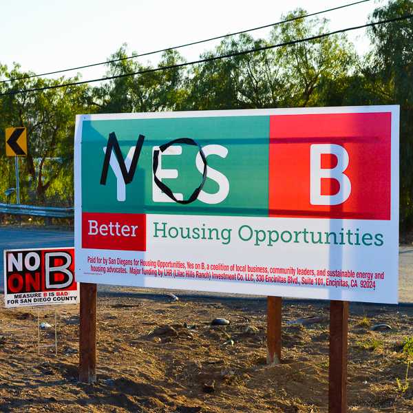 Opponents of San Diego County’s Measure B scribble NO with black tape along a YES on Measure B sign. Measure B would allow for the development of 1,700 homes north of Escondido. Oct 19, 2016. San Marcos, Calif. (Dylan Halstead/The Telescope)