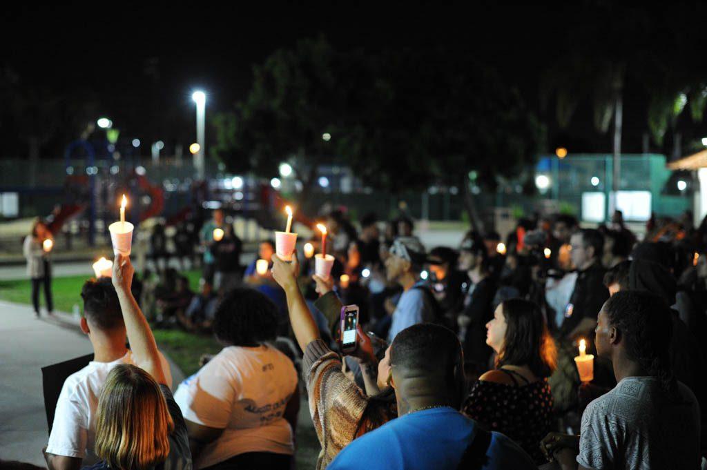 Peaceful protesters gather together on "National Day of Protest Against Police Brutality Rally & Light Brigade" in remembrance of Alfred Olango and other victims of institutionalized police brutality, in City Heights/Weingarten Library and Performance Annex, on Oct. 22, 2016. (Idmantzi Torres/The Telescope)