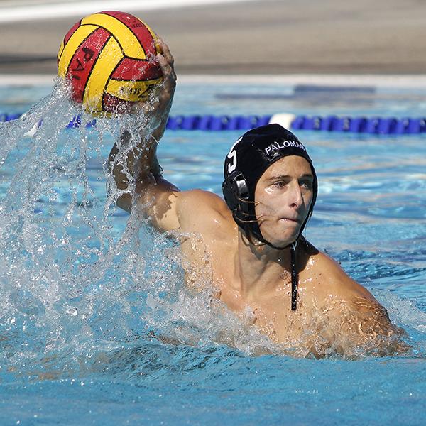 A male Palomar water polo player throws a ball with his right hand.