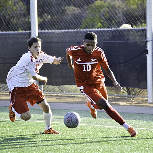 Palomar forward Josh Clay (10) rushes towards the endline with Imperial Valley center back Fabrizio Marchesini (11). Palomar defeated Imperial Valley 2-1 Nov. 1, 2016 on Minkoff Field. (Dylan Halstead/The Telescope)