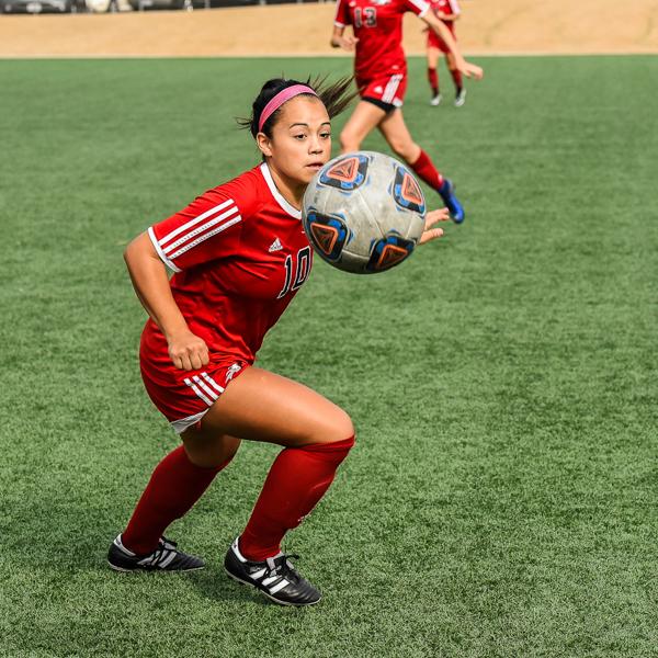 Comet's midfielder, Adriana Gutierrez, turns to take control of the ball as it is passed over her shoulder, three minutes into the first period. Despite their best efforts, the Comets were defeated by the Spartans on Oct. 28, at Minkoff Field. The final score was 4-1. (Mitchell Hill/The Telescope)