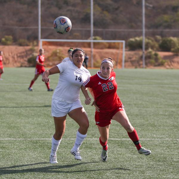 Palomar forward Grace Busby (22) pushes her way pass a Miramar defender. Palomar was defeated 0-4 by Miramar College on Nov. 4, 2016 at Minkoff Field. (Bruce Woodward/The Telescope)