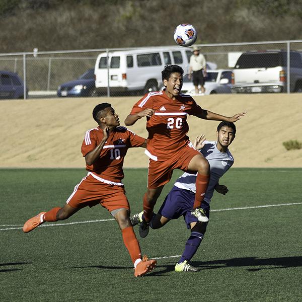 Palomar midfielder Luis Lopez (#20) heads the ball towards the goal while foward teammate Josh Clay (#10) watches on. Palomar was defeated 1-0 by Mesa College at Minkoff Field on Sept. 16, 2016. (Eric Szaras/The Telescope)