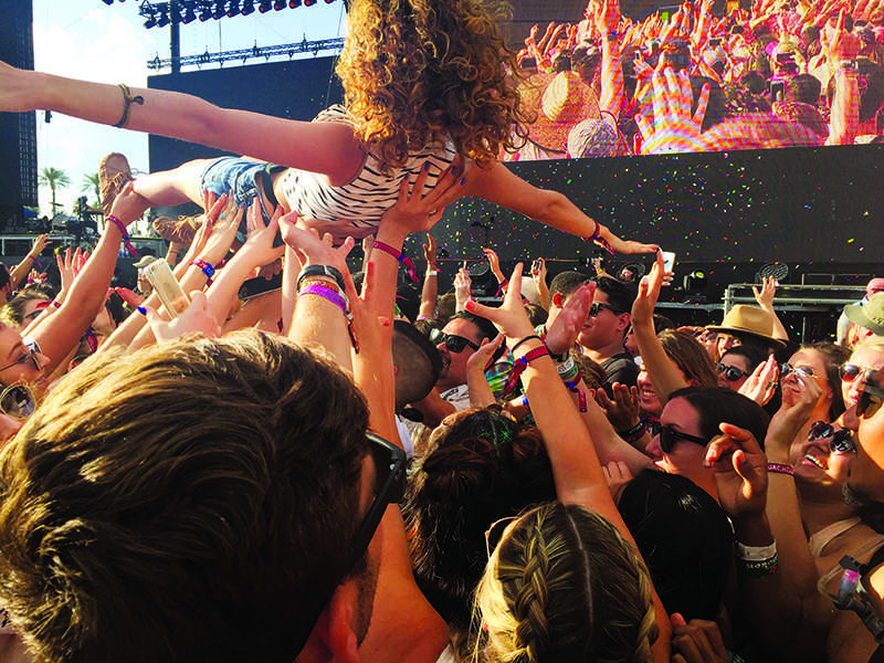 A woman crowd surfs amongst a crowd of festival attendees at the 2016 Coachella Music Festival in Indio, Calif. (Cristina Angel/The Telescope)