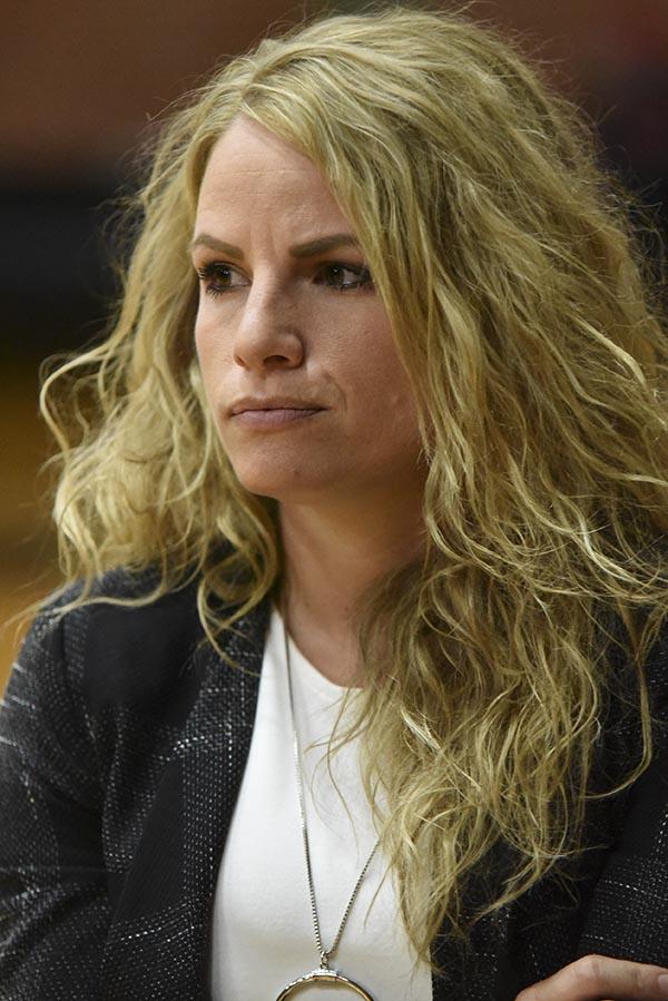 Palomar Head Coach Leigh Marshall, with wavy long blond hair, looks intently forward with her arms crossed in front of her chest.