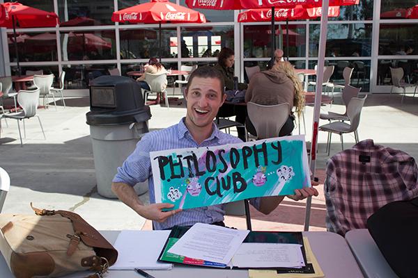 Forrest Ponsot, is seen holding a sign promoting the philosophy club as he waited for students to approach his booth Tuesday, Feb. 14, 2017, during club rush at Palomar College. (David Santillan/The Telescope)