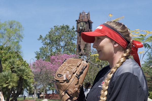 Crystal DesLauriers poses in front of the clock tower before leaving for an away game at San Diego City College on April 5. (Jacob Tucker/The Telescope)