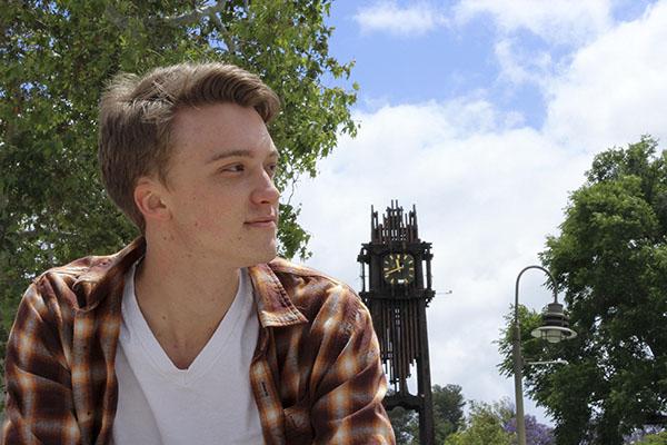 Jacob Tucker poses in front of the clocktower. (Justin Gonzalez/The Telescope)