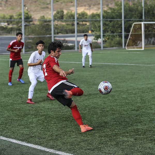 Yoel Sanchez makes a cross through San Diego City College defenders, Sept. 15, 2017 at Minkoff Field. (Larie Tobias Chairul/The Telescope)