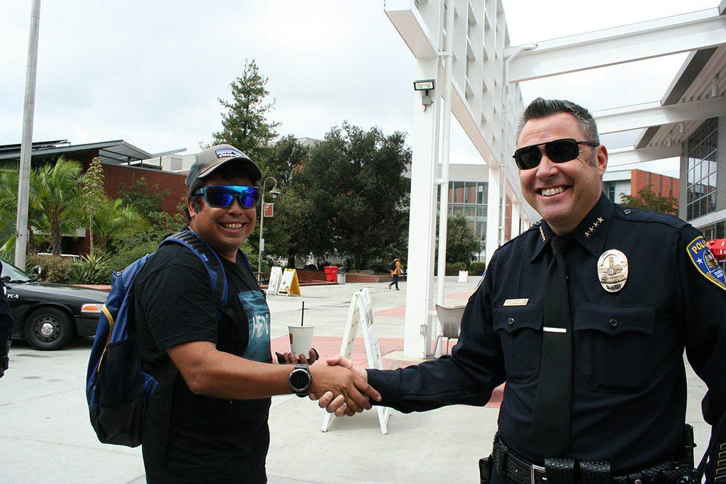 Palomar College Police Department Chief Chris Moore with student Mike Neill during Coffee With A Cop on Sept. 21, 2017. Neill stopped by the tables outside the cafeteria to "grab a free cup of coffee and thank the officers for all they do." (Marissa Boyd/The Telescope)