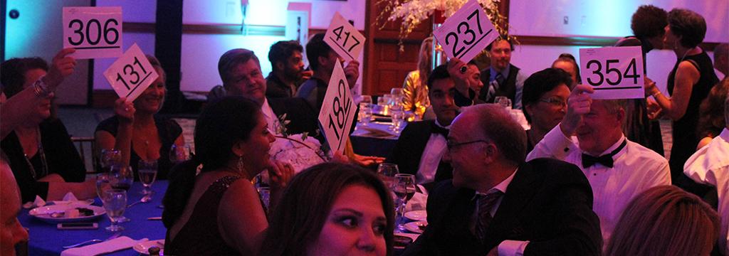 Guests at the Starlit Gala participate in a raise the paddle event to donate money to the Palomar Foundation on Sept. 9, 2017 at the Omni La Costa Resort and Spa. (Justin Gonzalez/The Telescope)
