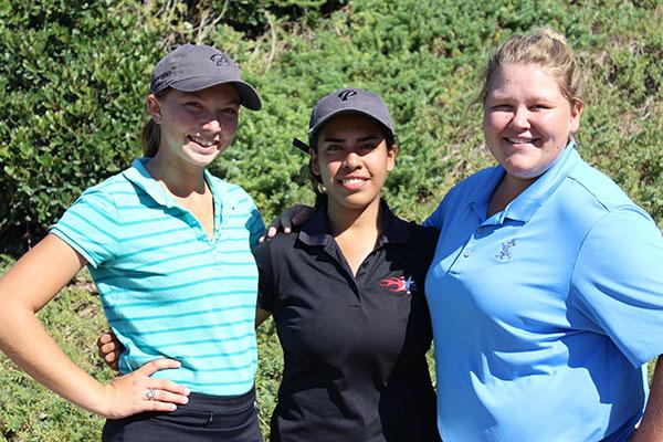 Three female Palomar golfers stand together with their arms on each others' shoulders.