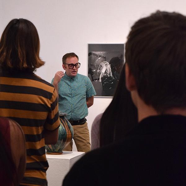 Guests listen to Guest Speaker Jones Von Jonestein, Assistant Curator and Art History Professor at Palomar College about why we collect during the opening reception of The Maker's Eye, gallery Talk. Oct. 5, 2017, Boehm Gallery, Palomar College. (Victoria Bradley/The Telescope)