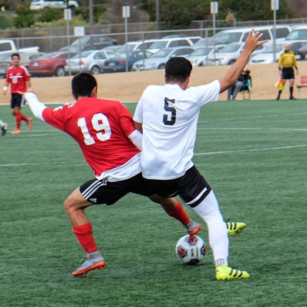 Miguel Valladolid fights to retain posession of the ball as San Bernardino’s Noe Granillo attacks during the Comets game against the Wolverines, Oct. 31, 2017. (Scott Engrav/The Telescope)