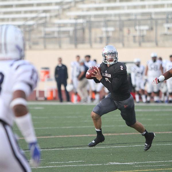 Quarterback Matt Romero looking for an opening to pass the ball during the beginning of Palomar's first homegame at Escondido High School on Sept. 16, 2017. This play put the Comets in position to score the first field goal of the game, final score Palomar 6 and Cerritos 37. (Julie Lykins/The Telescope)